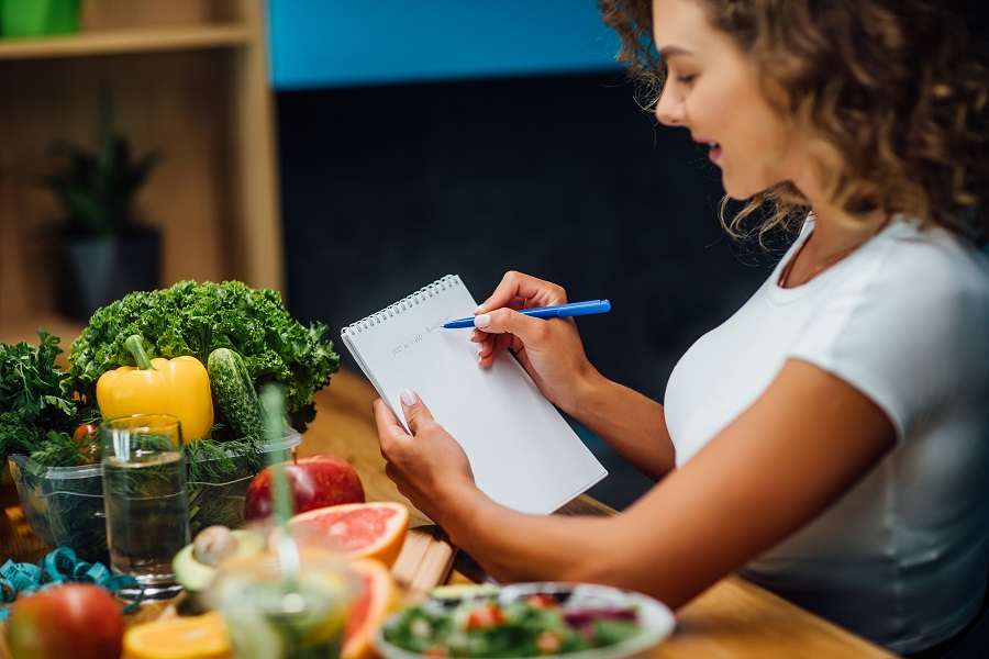 Young woman counting calories