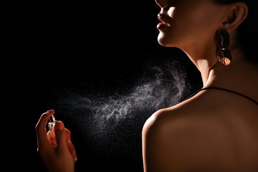 woman spraying perfume