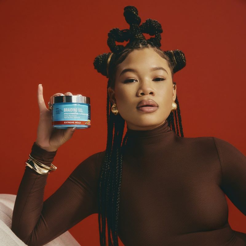 Storm Reid hold a Kiss Colors & Care product