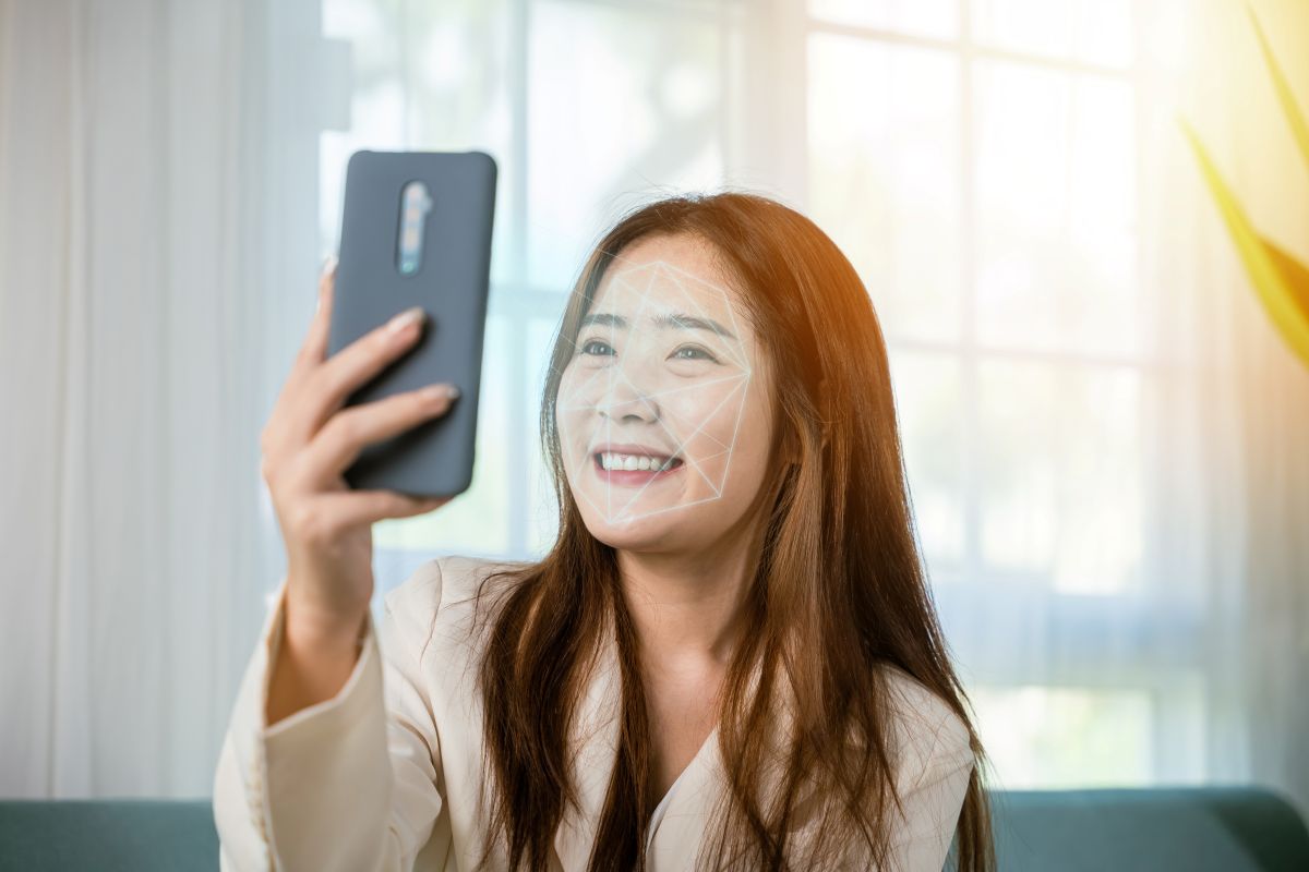 woman holds up phone to face