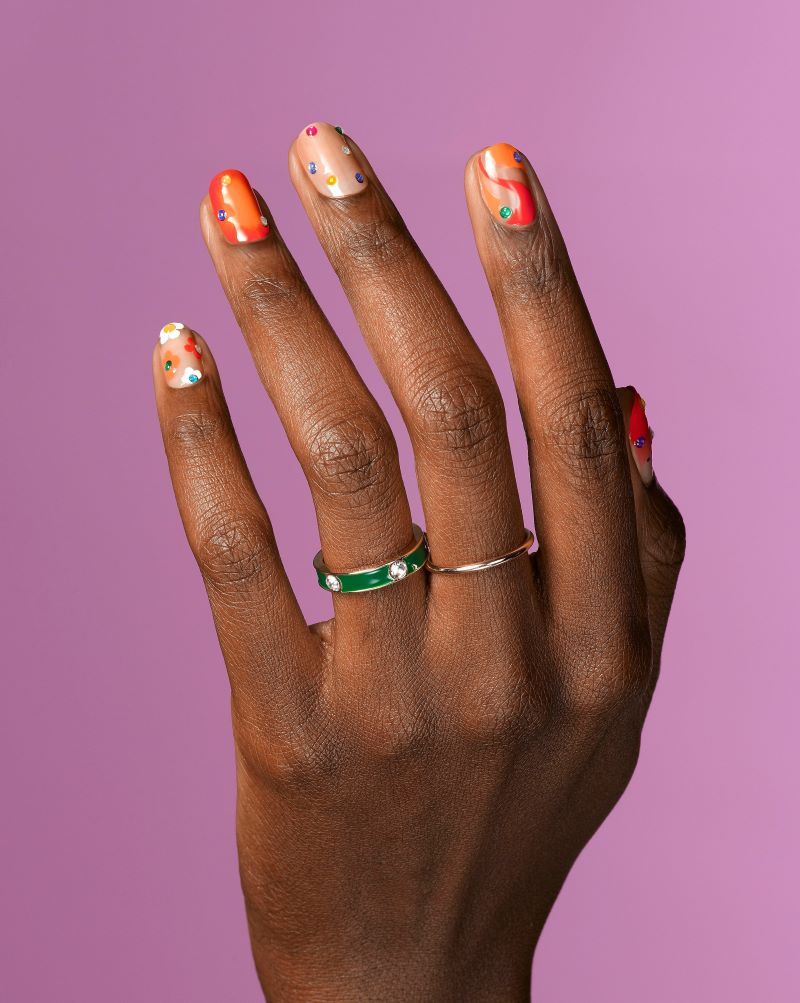 Manicured nails with dots of color.