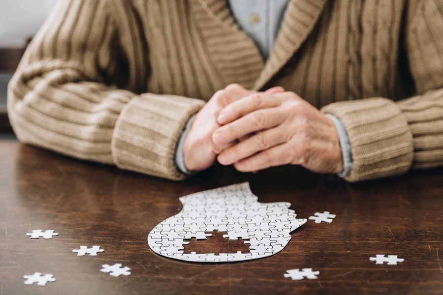 Elderly man solving a puzzle