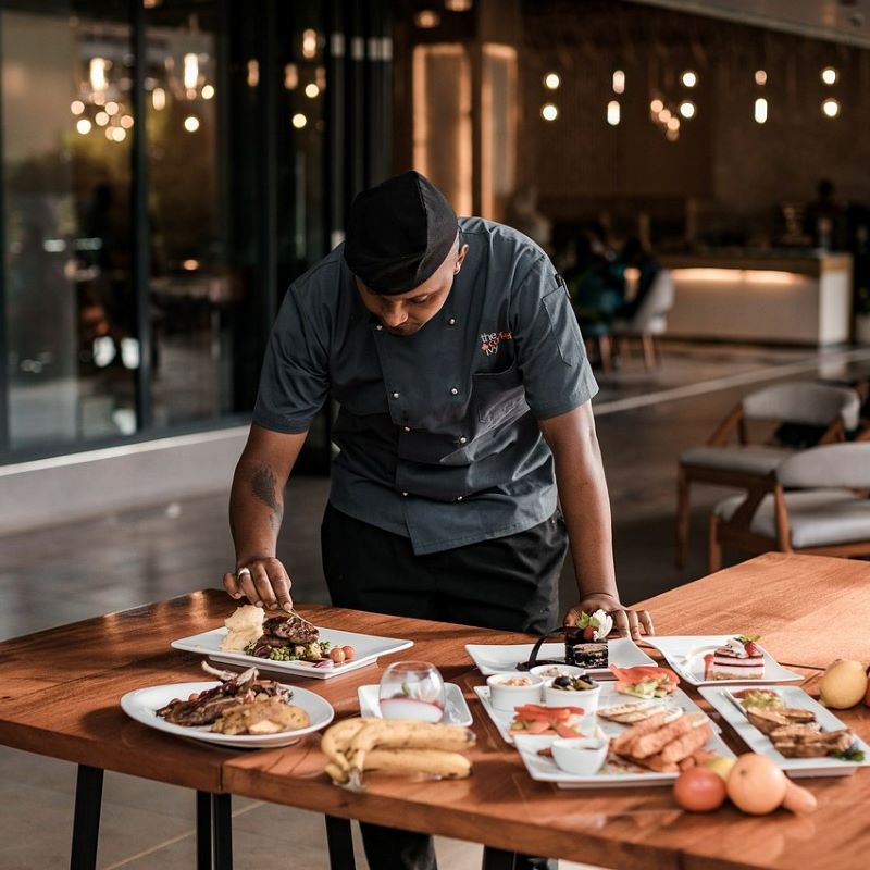 Chef with table of food.