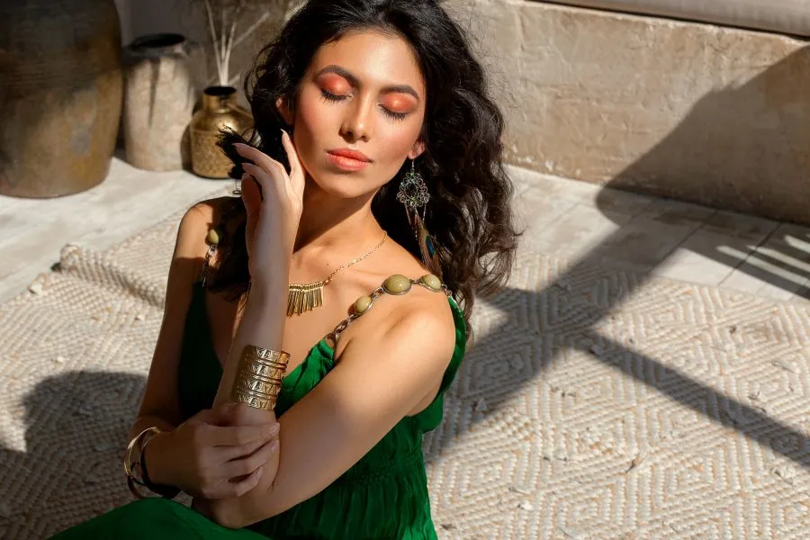 woman sits in the sun, eyes closed