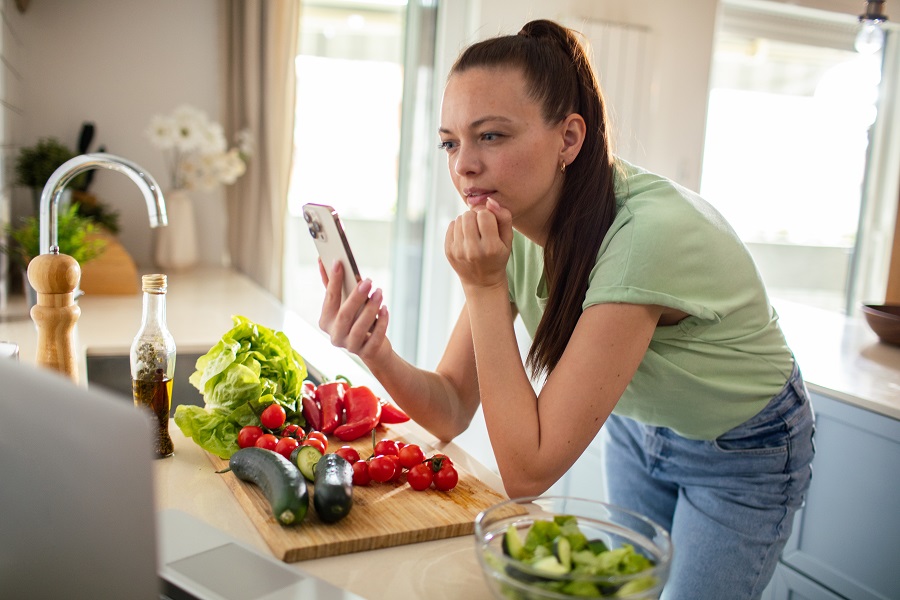 Woman using AI meal tracker smartphone tool