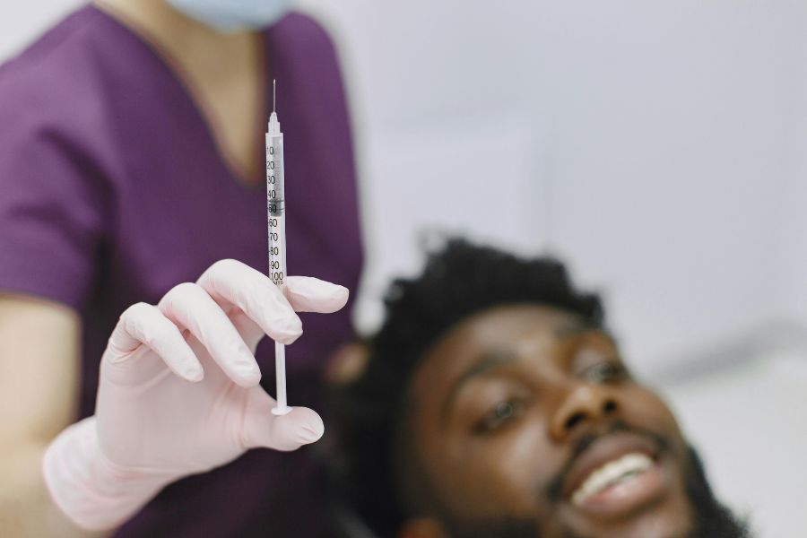 Man undergoing facial with injection