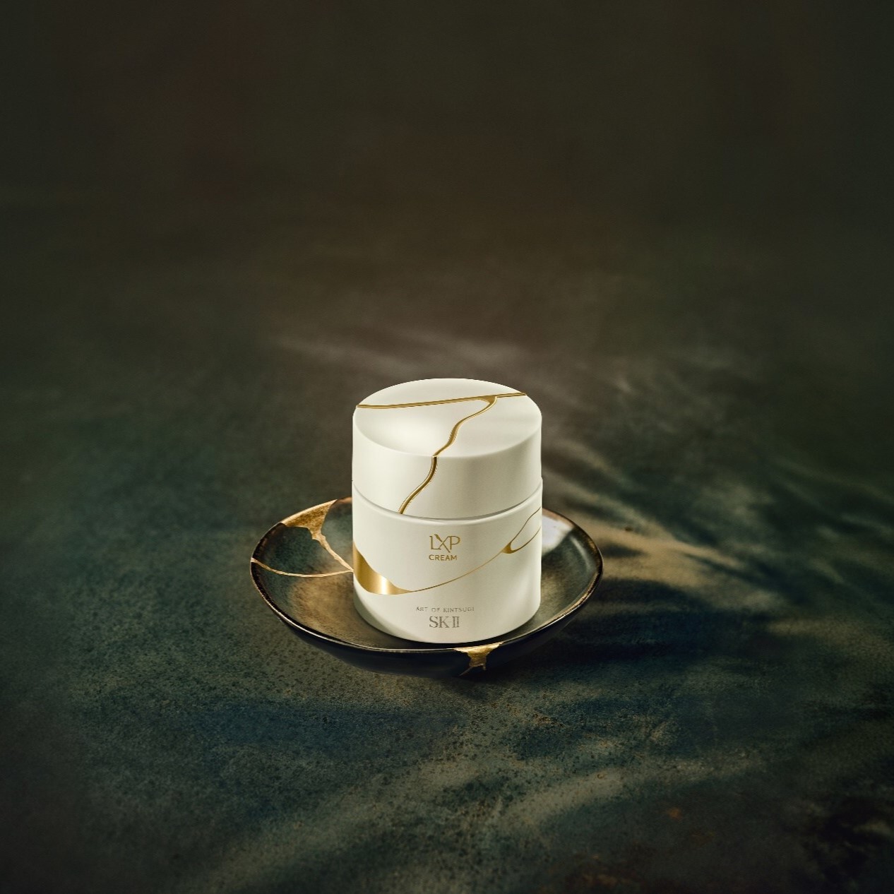 a cosmetics product with gold lines on white 