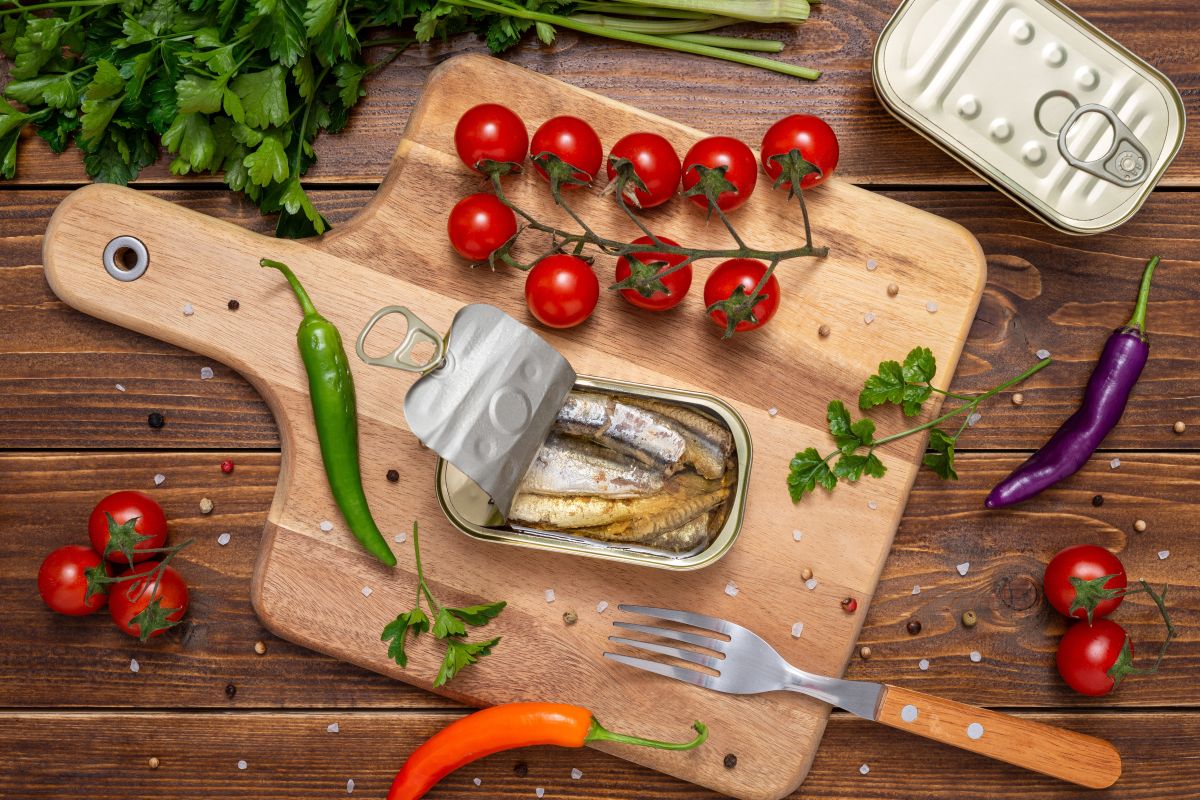 sardines in a can on a table with other vegetables