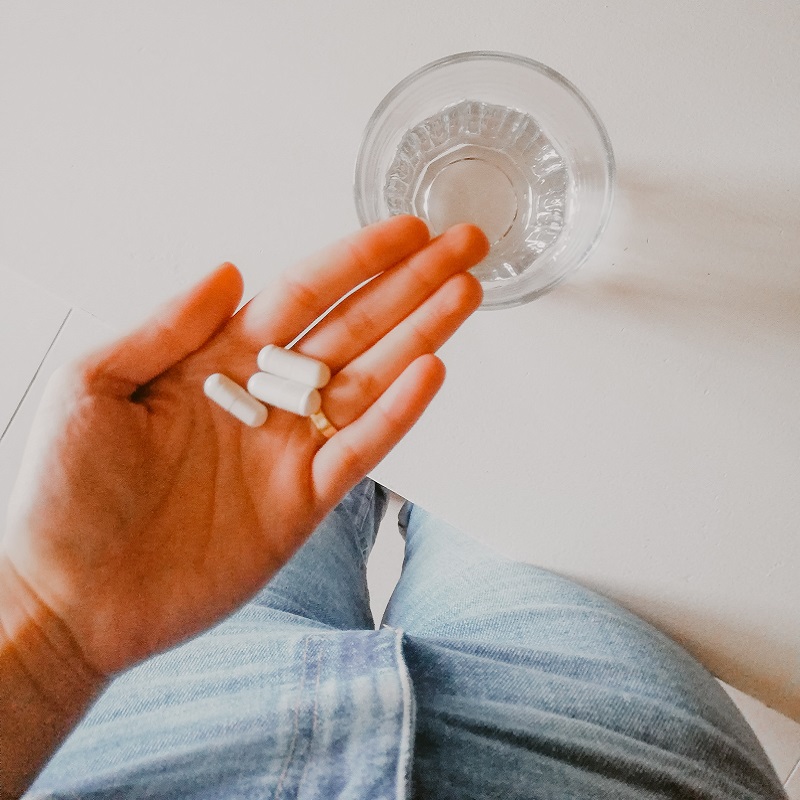 A person holding supplements.