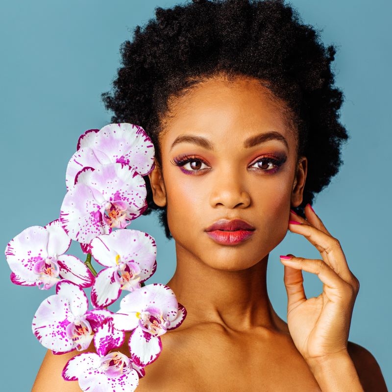 woman poses with orchids 