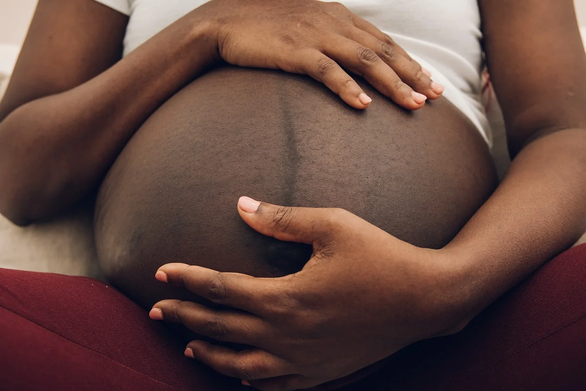 Pregnant woman holding her belly