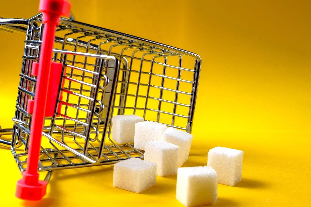 Mini toy shopping cart containing sugar cubes