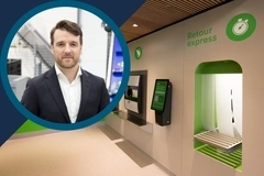 Image Man in a navy suit pictured alongside an automated express return station with a green self-service kiosk and parcel conveyor.