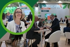 Nexira trade show booth with business meetings and a woman highlighted in a green circular frame Nexira trade show booth with business meetings and a woman highlighted in a green circular frame